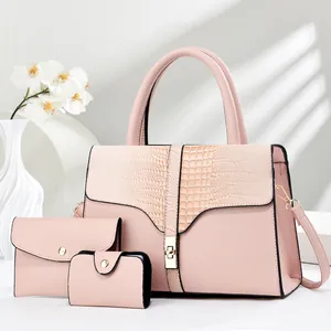 Detailed view of pink three-piece set with crocodile pattern tote bag and envelope clutch