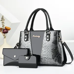 Detailed set of three textured snakeskin pattern bags including tote, pouch, and wallet
