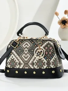 Ethnic woven pillow bag with leather handles and metallic rivet details on base