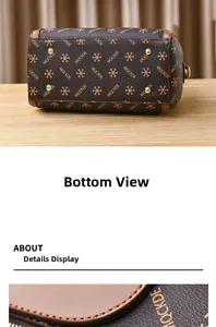 Detailed bottom view of Boston bag showing gold rivets and MQCKDE pattern print