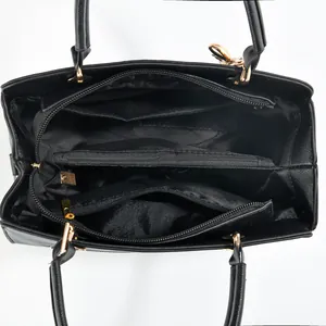 Top view of large capacity black tote with multi-compartment interior and golden zippers