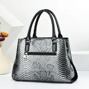 Close-up of the back zip pocket on a silver snakeskin textured large capacity tote bag