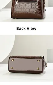 Detail of brown crocodile embossed tote bag back zipper pocket and metal bottom studs