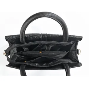 Top view of black tote bag showing multiple internal zipper compartments and storage layout