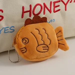Detailed view of plush Taiyaki coin purse with orange soft fabric and silver bead chain