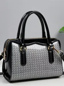 Fashionable Boston handbag with black patent leather and silver glitter texture panels