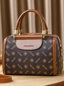 Classic brown Boston handbag with printed pattern and caramel leather trim, shown in full view