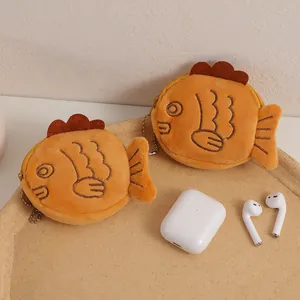 Close-up of cute cartoon fish plush coin purse with zipper and metal keychain clip