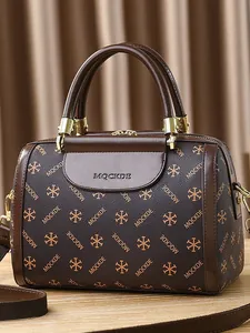 Classic dark brown Boston bag with monogram pattern and gold hardware top handles