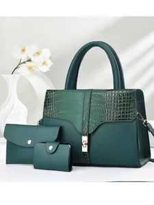 Three-piece dark green tote bag set with crocodile embossed texture and gold hardware