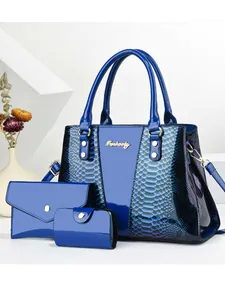 Three-piece women's tote set in blue snakeskin texture with metallic logo and gold hardware