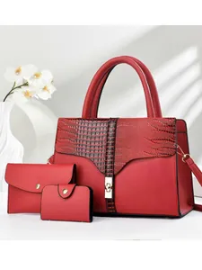 Three-piece red faux leather tote bag set with crocodile texture and golden hardware