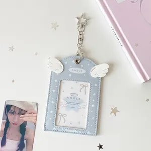 Detail of light blue PU leather card holder with angel wings and star keychain hook