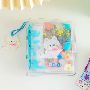 Detail of transparent PVC mini photo album with 3-ring binder and cute cat charm pendant