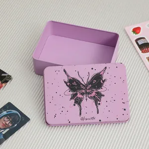 Close-up of purple metal storage box with gothic butterfly print for stationery and cards