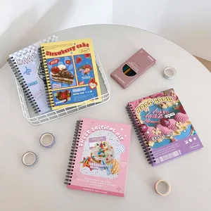 Detail of four spiral notebooks featuring strawberry cake and dessert cartoon illustrations