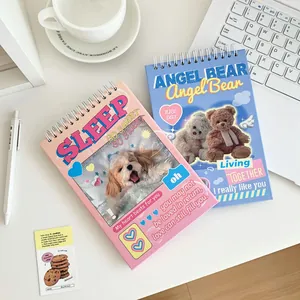 Top-down view of pink and blue spiral planners with cute animal designs on a desk