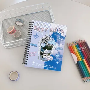 Detail of cute sky pattern spiral notebook with black coil binding on a desk