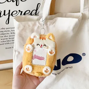 Close-up of plush orange cat card holder with transparent window and metal hook