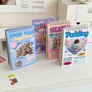 Close-up of four vintage flip spiral planners with cute animal and dessert themes