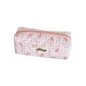 Creamy plaid pencil case with pink bows and quilted fabric in a portable design