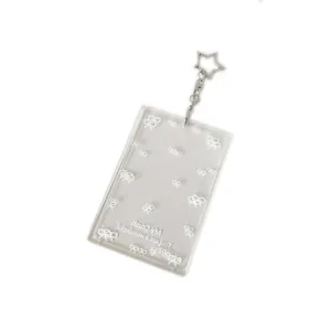 Clear acrylic photo card holder keychain with star hook and white bow patterns