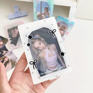 Detail view of white acrylic photocard holder with star and bow motifs and English text