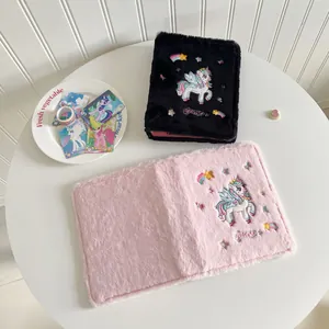 Detail of plush unicorn binder cover featuring soft faux fur and rainbow embroidery