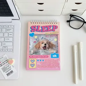 Close-up of spiral weekly planner with cute dog design on a desktop workspace