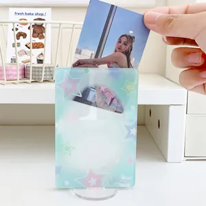 Close-up of blue bow acrylic photocard holder with transparent round base stand