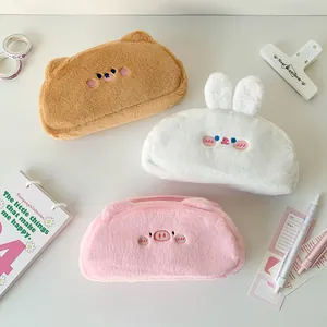 Detailed view of three soft plush animal pencil cases in brown, white and pink colors