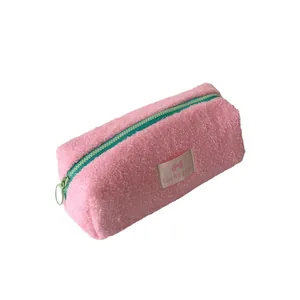 Rosa Plüsch-Mäppchen mit grünem Reißverschluss und Lucky Gate Label auf weiß