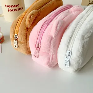 Detail of plush pencil cases with soft texture and heart-shaped metal zipper pulls