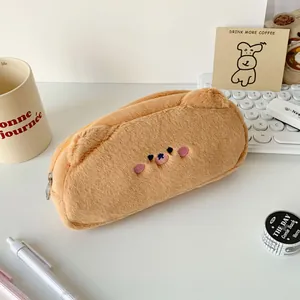 Macro detail of plush brown bear pencil case with soft embroidery and silver zipper