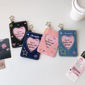 Detail of four denim card holders with star hooks and heart-shaped windows for photocards