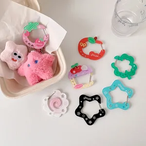 Detailed view of colorful acrylic carabiners and cute plush star pendants for bags