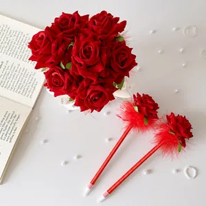 Detail of red rose flower bouquet gift set with decorative feather ballpoint pens