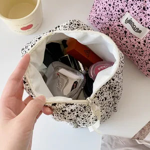 Ink splatter quilted makeup bag with zipper closure and spacious cosmetic storage