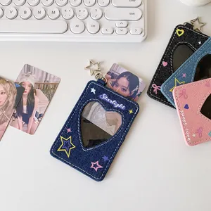 Detail of denim star photocard holders with heart windows and star-shaped metal hooks