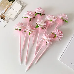 Detail showing artificial rose and feather decoration on pink ballpoint gift pens