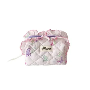 Pink quilted fabric organizer with butterfly prints and elegant ruffled edge detail