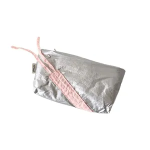 Silver metallic drawstring stationery bag with pink ribbons and a minimalist design