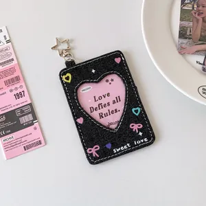 Detail of Y2K black denim card holder with star keychain and heart-shaped transparent window