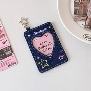 Detail view of denim star photo card holder with heart window and silver star keychain