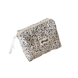 Ink splatter quilted makeup bag with soft texture and white ribbon zipper puller
