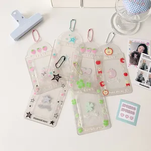 Flat lay of assorted clear glitter PVC card holders with colorful bead chains and star patterns