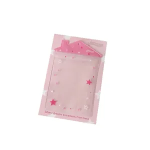 Pink house-shaped clear card holder with star patterns for plush dolls and photocards