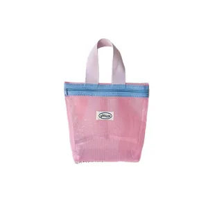 Pink mesh storage bag with blue zipper and handles for portable travel toiletries