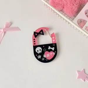 Detail view of a sweet-cool acrylic carabiner with skull, black bow, and heart motifs