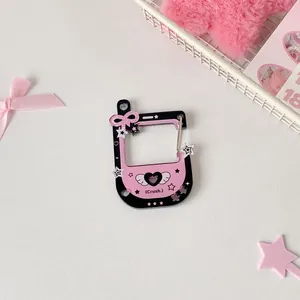Detail view of a pink acrylic heart-themed game console keychain with metal clip